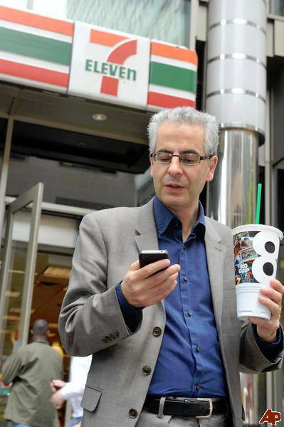 Nick Pope outside a 7-Eleven store, checking his phone, for a client campaign